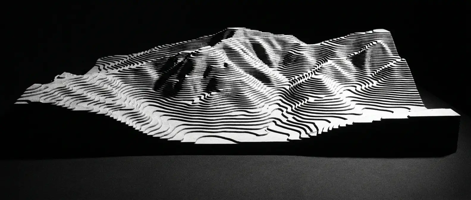 Raking light across a layered topographic contour model, representing brand knowledge optimisation