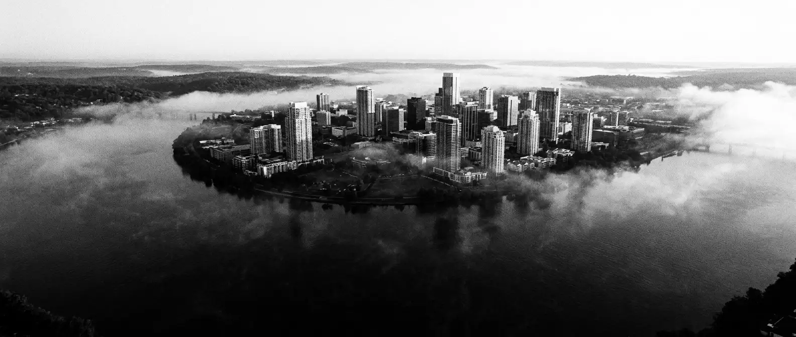 Aerial view of the Brisbane River bending around the city at dawn, representing AI search visibility for Brisbane businesses