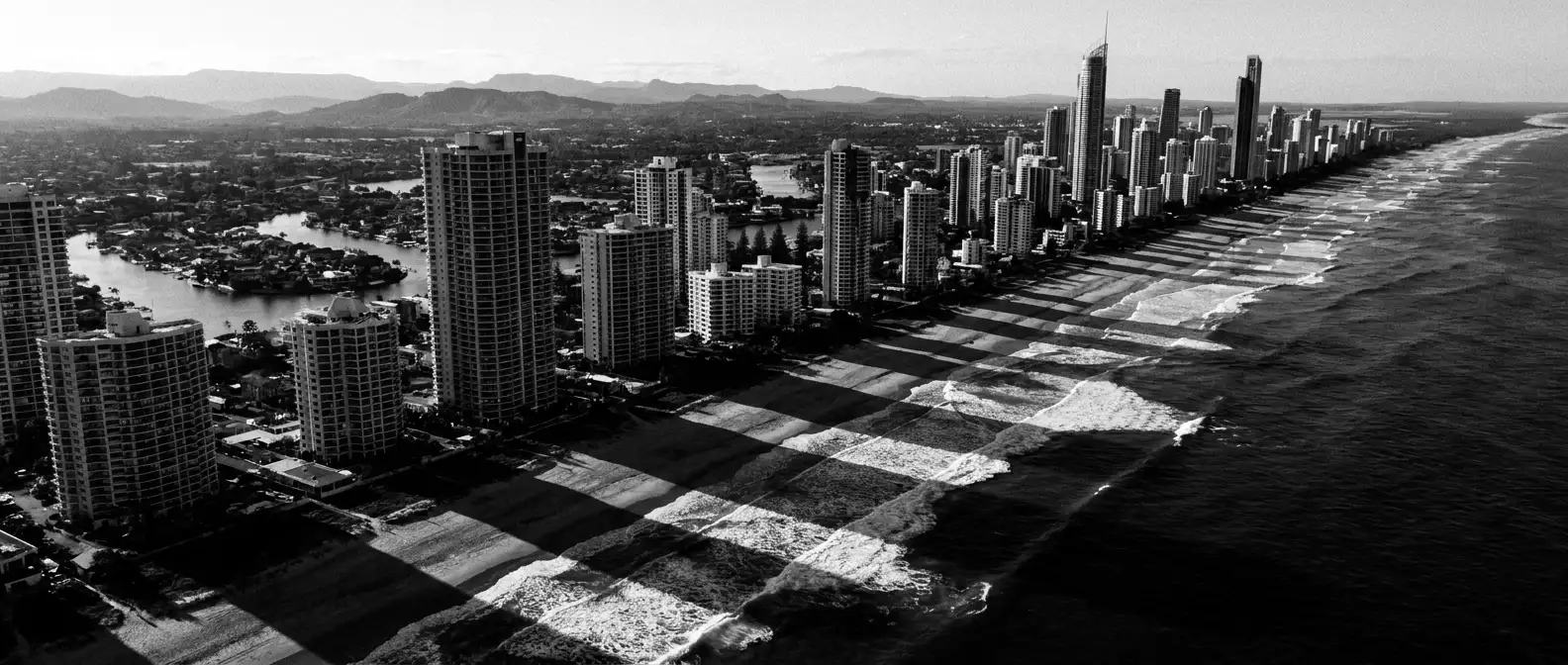 Aerial view of Gold Coast beachfront towers striping the surf beach, representing AI search visibility for Gold Coast businesses