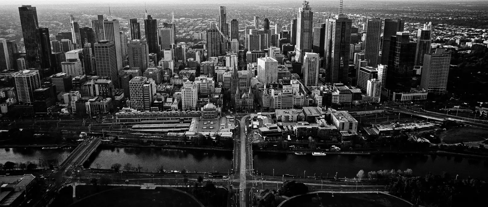 Aerial view of Melbourne CBD towers and street grid along the river, representing AI search visibility for Melbourne businesses