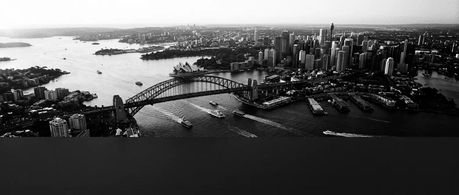 Aerial view of Sydney Harbour with the harbour bridge and opera house, representing AI search visibility for Sydney businesses