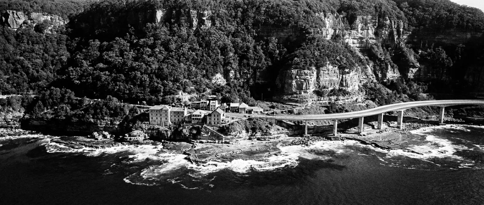 The Illawarra escarpment above the Wollongong coastline and cliff-edge bridge, representing AI search visibility for Wollongong businesses