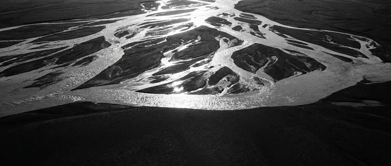 Aerial view of a braided river delta fanning into hundreds of channels, representing generative engine optimisation