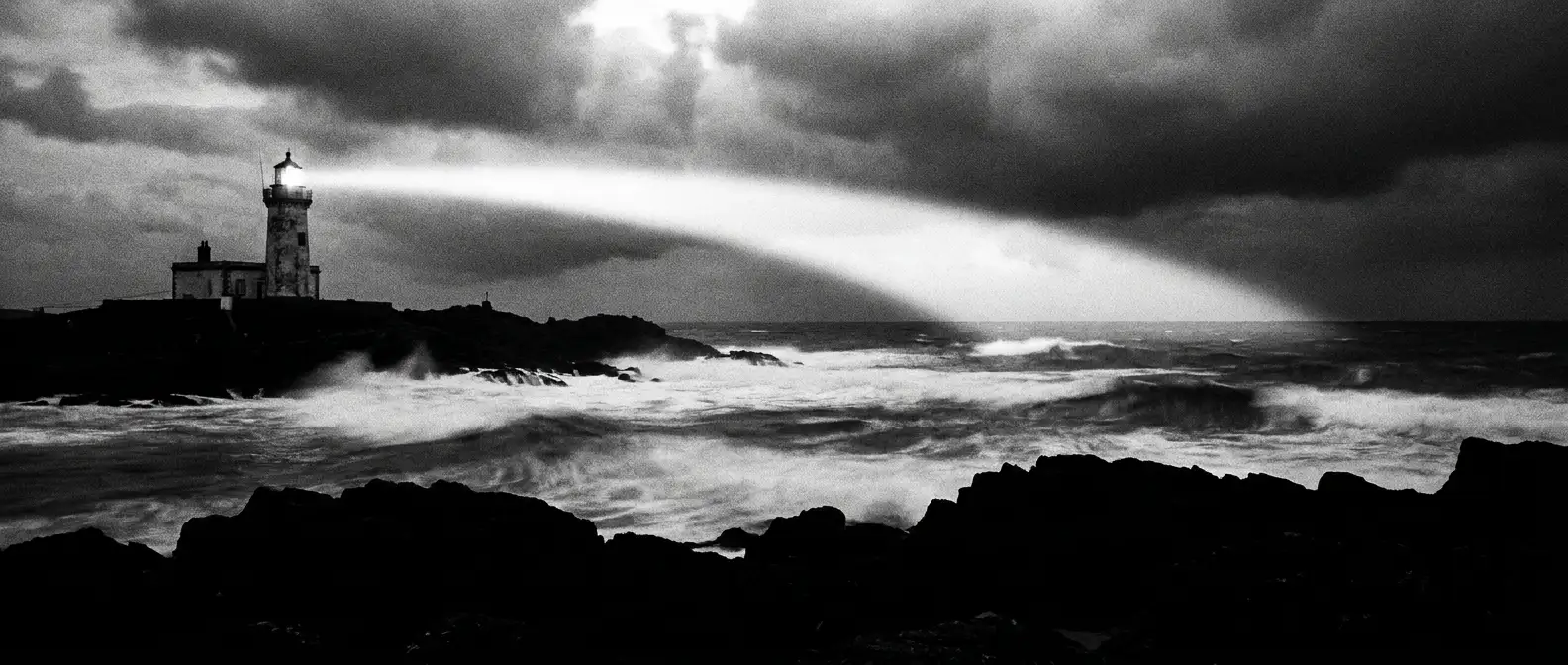 Lighthouse beam sweeping over breaking surf at dusk, representing ongoing visibility management